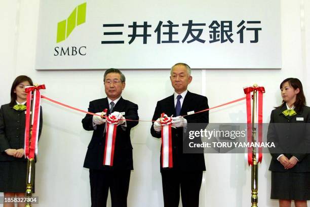 Chairman Akishige Okada and President Yoshifumi Nishikawa cut a tape to commemorate the opening of their new Sumitomo Mitsui Banking Corp....