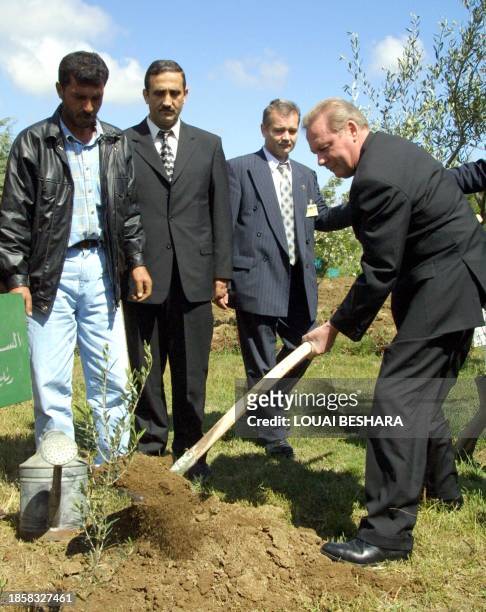 Slovakian President Rudolf Schuster plants a tree in a public garden in the destroyed Syrian town of Quneitra in the Golan Heights 05 April 2001....