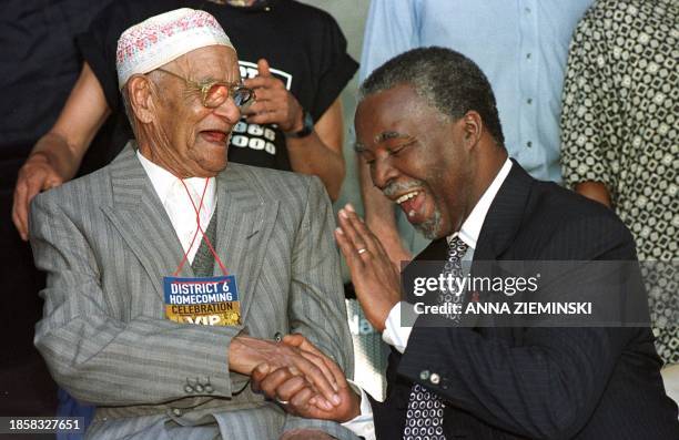 South African president Thabo Mbeki shares a light moment with former District 6 resident 100 year-old Mr Bessier during a homecoming ceremony in...