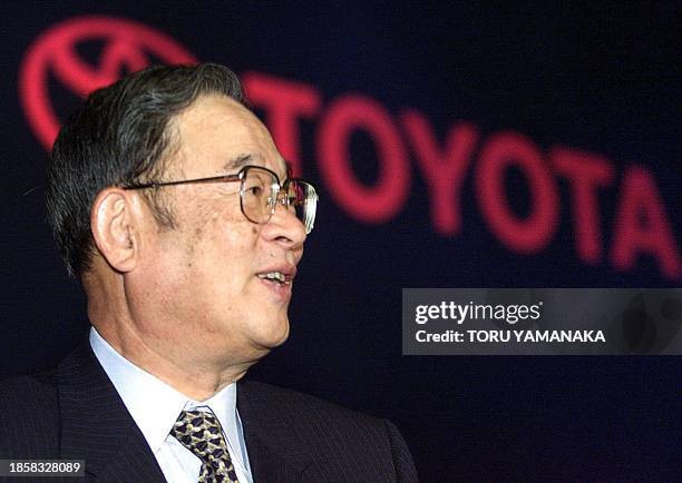 President of Japanese auto giant Toyota Motor, Fujio Cho smiles in front of the company's logo during a press preview for its new five-door vehicle...