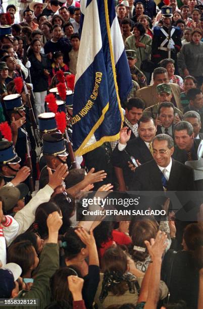 Honduran President Carlos Flores greets supporters 25 January 2001 on his way to the Legislative headquarter, to assist to the fourth and last...