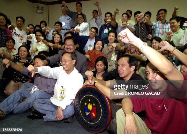 Private prosecutors and staff gather showing a seal of the House of Representatives chanting "Estrada resign", 17 January 2001, after prosecutors and...