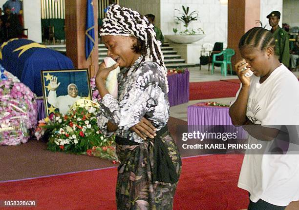 Democratic Republic of Congo women cry 22 January 2001 as they pass next to the coffin of their slained president Laurent Desire Kabila as people pay...