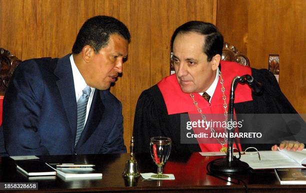 Venezuelan President Hugo Chavez talks with the president of the Supreme Court of Justice Ivan Ricon during an ceremony in Caracas, Venezuela, 11...