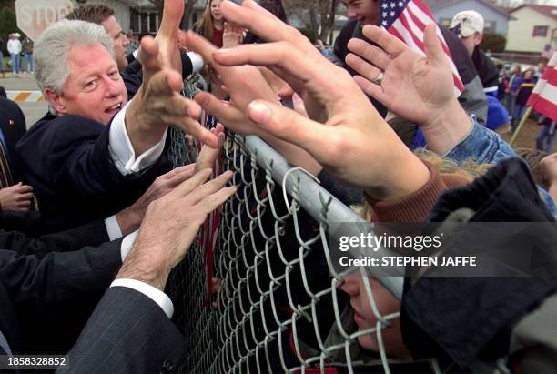 President Bill Clinton greets local residents in Kearney, Nebraska during an impromptu stop prior to attending the commencement ceremony at the...