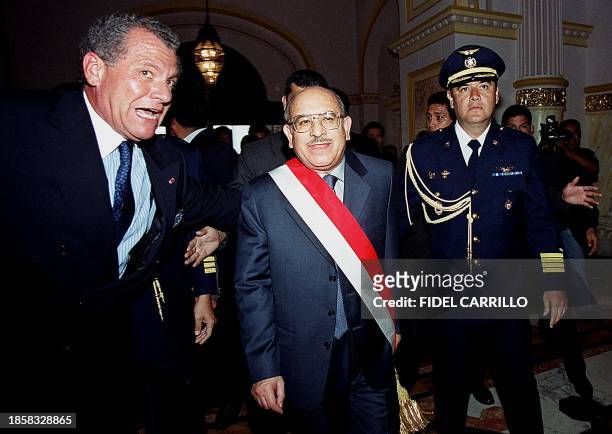 The new president of Peru, Valentin Paniagua is accompanied by unidentified people as he enters the Government Palace in Lima, 22 November 2000. El...