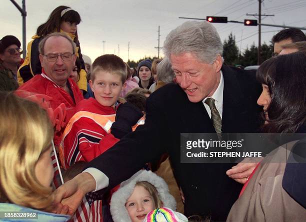 President Bill Clinton greets local residents during an impromptu stop prior to attending the commencement ceremony at the University of Nebraska, 08...