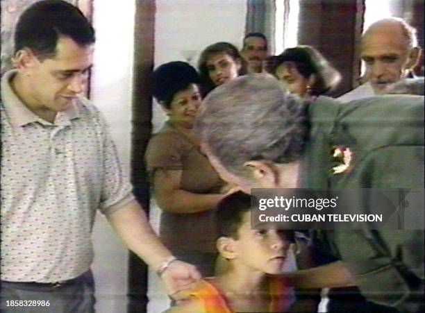 In this image taken 14 July 2000 for Cuban television and released 05 December 2000 in Havana, Cuban President Fidel Castro hugs Elian Gonzalez. The...