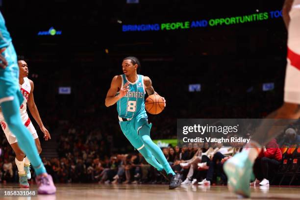 Nick Smith Jr. #8 of the Charlotte Hornets handles the ball during the game against the Toronto Raptors on December 18, 2023 at the Scotiabank Arena...