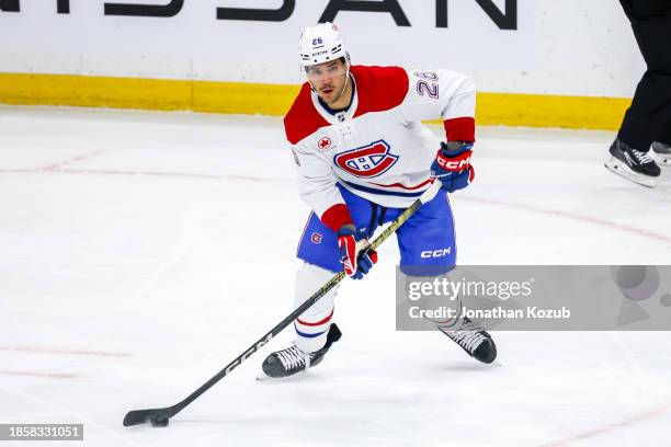 Johnathan Kovacevic of the Montreal Canadiens plays the puck during first period action against the Winnipeg Jets at the Canada Life Centre on...