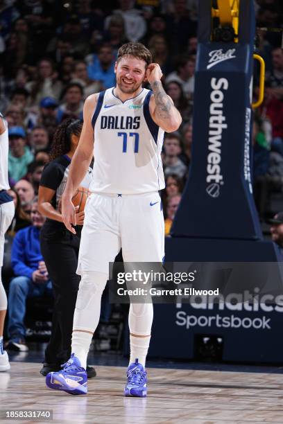 Luka Doncic of the Dallas Mavericks smiles during the game against the Denver Nuggets on December 18, 2023 at the Ball Arena in Denver, Colorado....