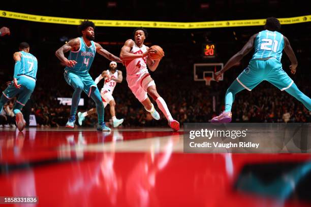 Scottie Barnes of the Toronto Raptors drives to the basket during the game against the Charlotte Hornets on December 18, 2023 at the Scotiabank Arena...