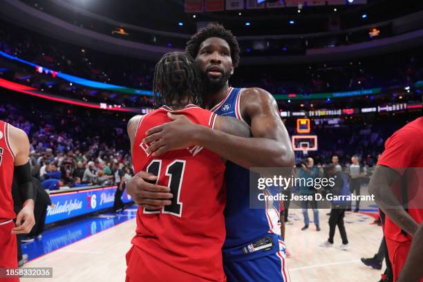 Joel Embiid of the Philadelphia 76ers hugs DeMar DeRozan of the Chicago Bulls after the game on December 18, 2023 at the Wells Fargo Center in...