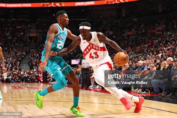 Pascal Siakam of the Toronto Raptors drives to the basket during the game against the Charlotte Hornets on December 18, 2023 at the Scotiabank Arena...