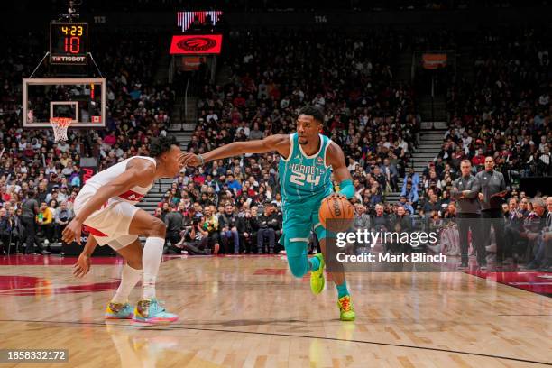 Brandon Miller of the Charlotte Hornets dribbles the ball during the game against the Toronto Raptors on December 18, 2023 at the Scotiabank Arena in...