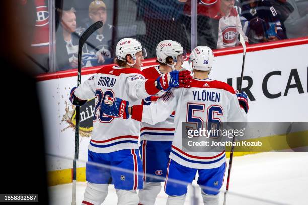 Christian Dvorak, Brendan Gallagher and Jesse Ylonen of the Montreal Canadiens celebrate a second period goal against the Winnipeg Jets at the Canada...