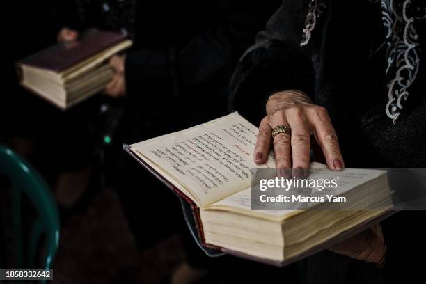 Congregation attend Sunday mass prayer service in a makeshift worship area in the basement of the Mar Maroun Maronite Church, in Jish, Israel,...