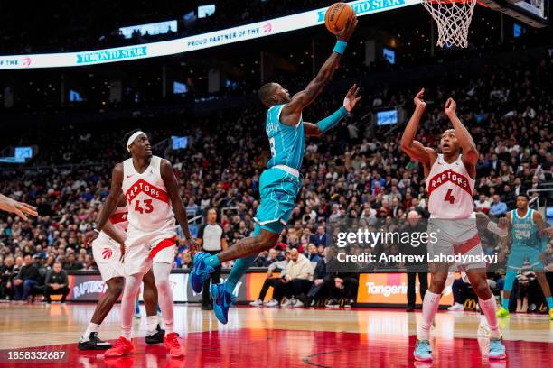 Terry Rozier of the Charlotte Hornets goes to the basket against Scottie Barnes of the Toronto Raptors during second half NBA action at Scotiabank...