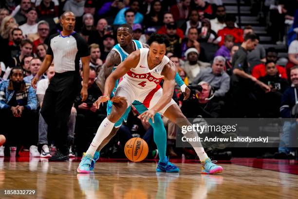 Terry Rozier of the Charlotte Hornets defends against Scottie Barnes of the Toronto Raptors during second half NBA action at Scotiabank Arena on...