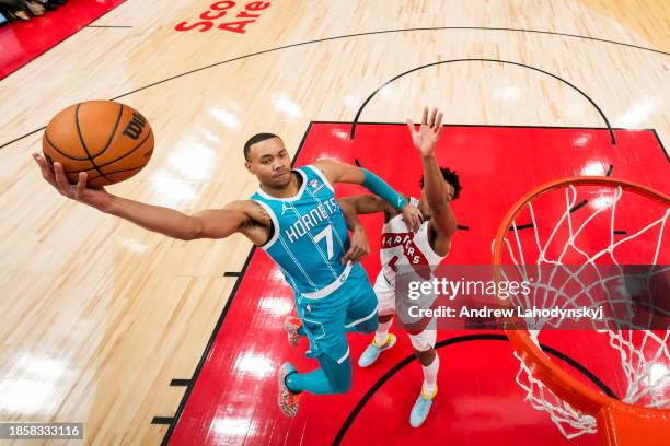 Bryce McGowens of the Charlotte Hornets goes to the basket against Scottie Barnes of the Toronto Raptors during first half NBA action at Scotiabank...
