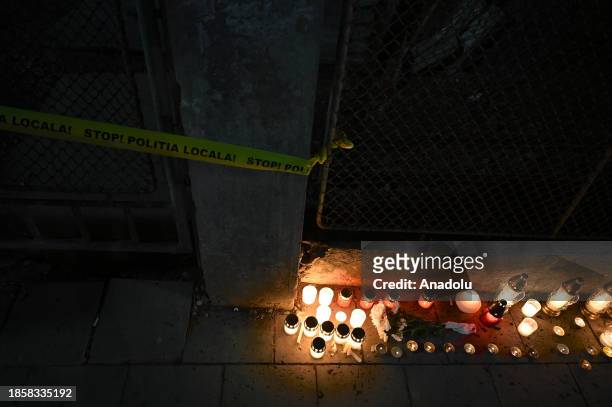 Candles are lit around the high school where four were trapped under a fallen wall in Odorheiu Secuiesc, Romania on December 18, 2023. A wall of the...