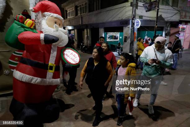 Group of people is waiting to board the new Christmas Train that is circulating in the streets of Santiago Zapotitlan Tlahuac, Mexico City, as part...