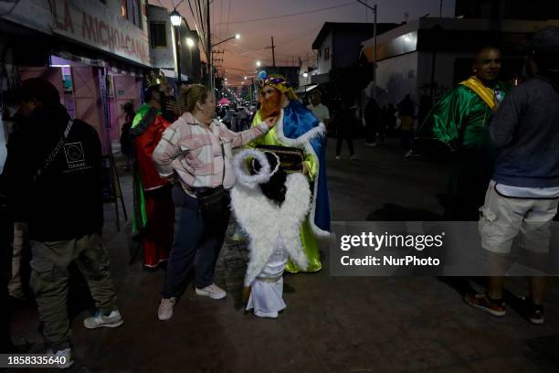 Group of people is hoping to board the new Christmas Train that is circulating in the streets of Santiago Zapotitlan Tlahuac, Mexico City, as part of...