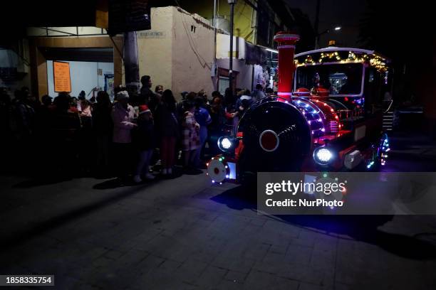 New Christmas Train is circulating through the streets of Santiago Zapotitlan Tlahuac, Mexico City, where dozens of people are boarding it as part of...