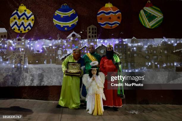 Group of people is hoping to board the new Christmas Train that is circulating in the streets of Santiago Zapotitlan Tlahuac, Mexico City, as part of...