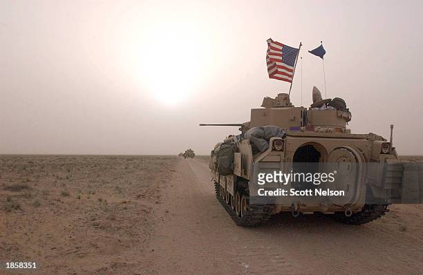 Army 3rd Division 3-7 Bradley fighting vehicles take up a position along a road March 19, 2003 inside the demilitarized zone between Kuwait and Iraq....