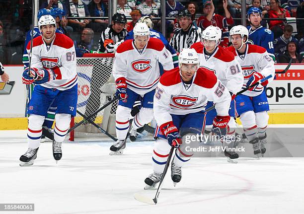 Francis Bouillon of the Montreal Canadiens and his teammates skate to the bench after a goal during their NHL game against the Vancouver Canucks at...