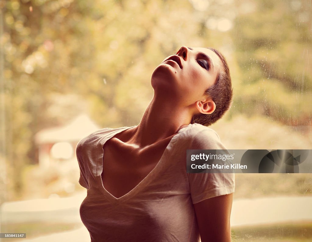 Woman with buzz haircut leaning back