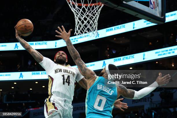 Brandon Ingram of the New Orleans Pelicans dunks the ball while being defended by Miles Bridges of the Charlotte Hornets during the first period of...
