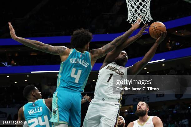 Zion Williamson of the New Orleans Pelicans drives to the basket against Nick Richards of the Charlotte Hornets during the first period of the game...