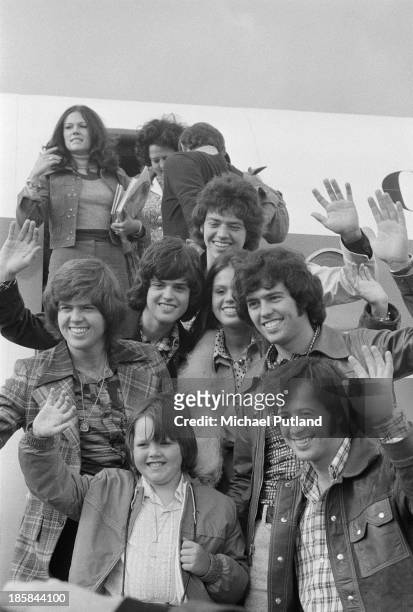 American pop group The Osmonds arrive at Glasgow Airport for a date at the Apollo on the British leg of their European tour, 25th October 1973....