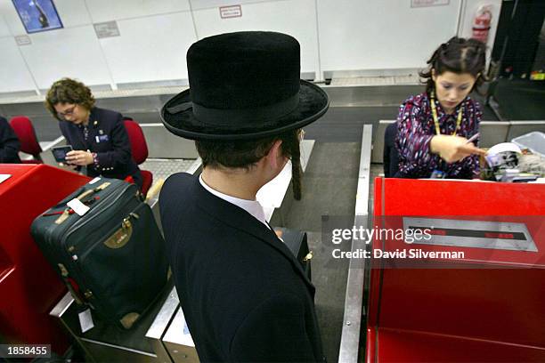 An ultra-Orthodox Jewish man checks-in for British Airways' last flight out of Israel at Ben Gurion Airport March 19, 2003 near Tel Aviv, Israel....