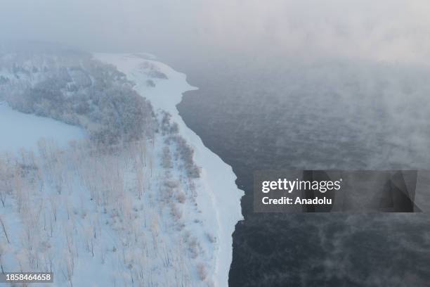 An aerial view of the Communal Bridge over the Yenisei River during the winter season as the temperature is minus 30 degrees in Krasnoyarsk, Russia...