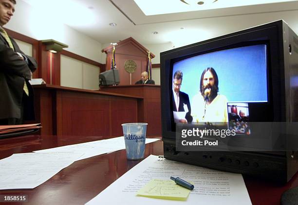Brian Mitchell, a suspect in the Elizabeth Smart abduction, is seen on a video screen from jail during his first court appearance March 19, 2003 in...