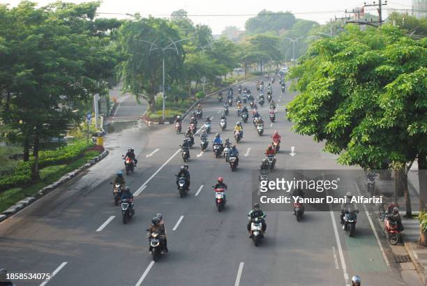 people going to work. - indonesia bikes traffic stock pictures, royalty-free photos & images