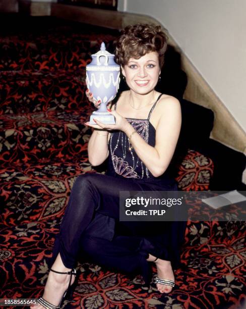 English singer and actress Elaine Paige poses for a portrait with a Wedgwood vase in London, England, December 3, 1978.