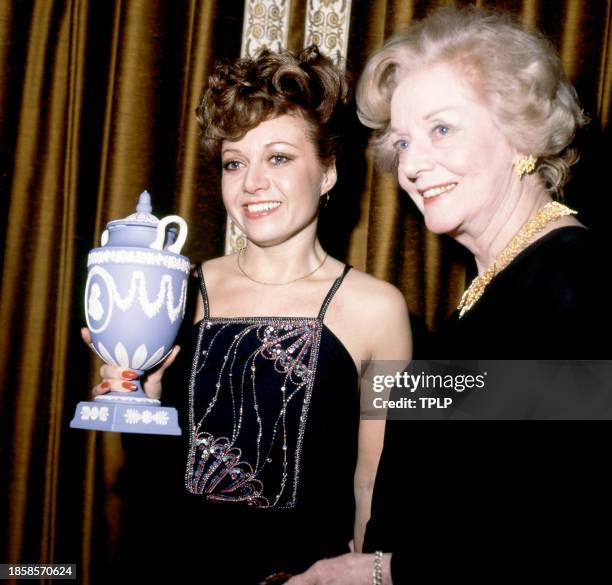 English singers and actresses Elaine Paige and Evelyn Laye pose for a portrait with a Wedgwood vase in London, England, December 3, 1978.