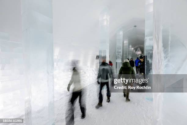 Visitors walk through the main hall at Icehotel 34 on December 15, 2023 in Jukkasjarvi, Sweden. Since 1989, the Icehotel - part hotel, part art...