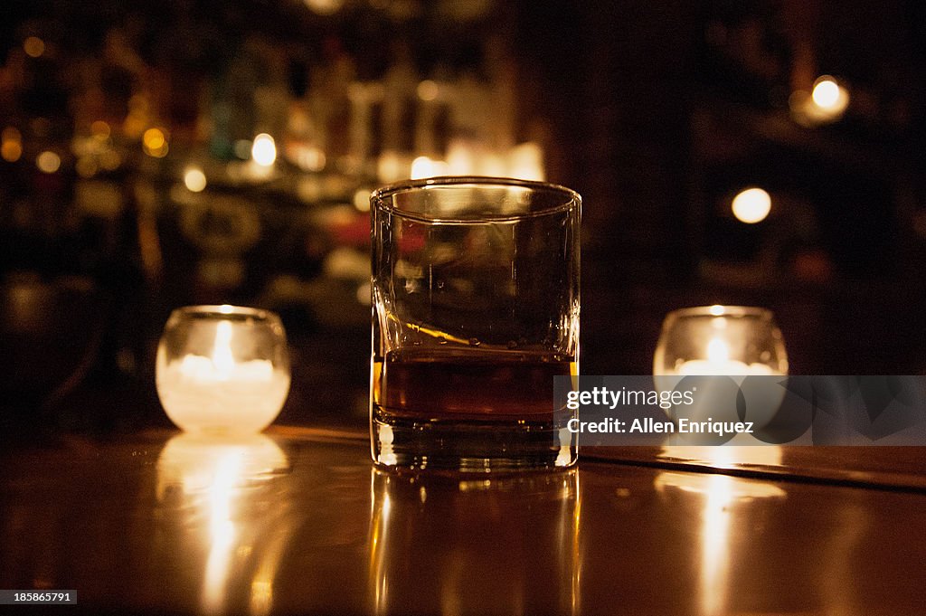 Whiskey, neat, between 2 candles in an NYC bar