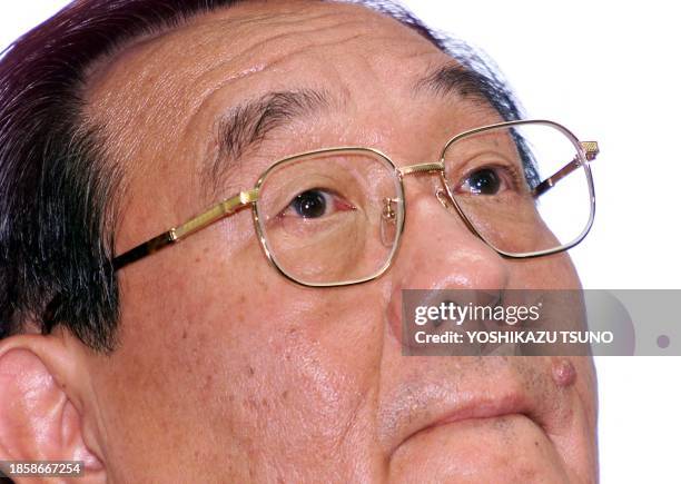 Japan's tire maker Bridgestone Predident Shigeo Watanabe bites his lips and listens to a question at a press conference as the Bridgestone/Firestone...