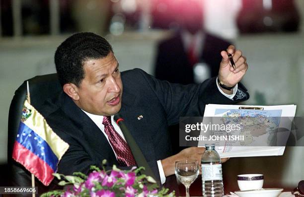 Venezuelan President Hugo Chavez points to a map of Venezuela to indicate areas in Venezuela to further industrial and agricultrual growth 29 May...