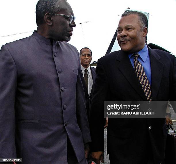 The Secretary General of the Community of the Caribbean Edwin Carrington , walks next to the president and agent chief executive of Barbados Owen...