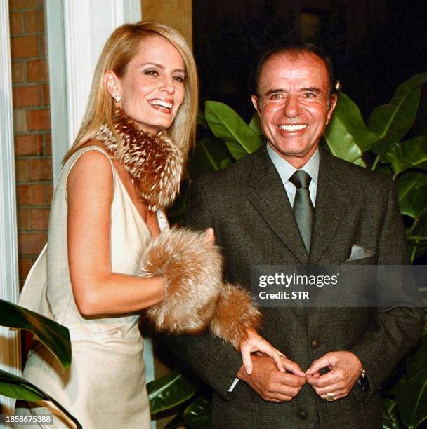 Former Argentine President Carlos Menem escorts his fiance Cecilia Bolocco on her 36th birthday, 19 May, 2001 in Santiago, Chile. The couple will...