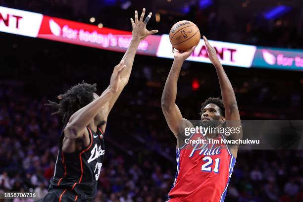 Joel Embiid of the Philadelphia 76ers shoots past James Wiseman of the Detroit Pistons during the third quarter at the Wells Fargo Center on December...