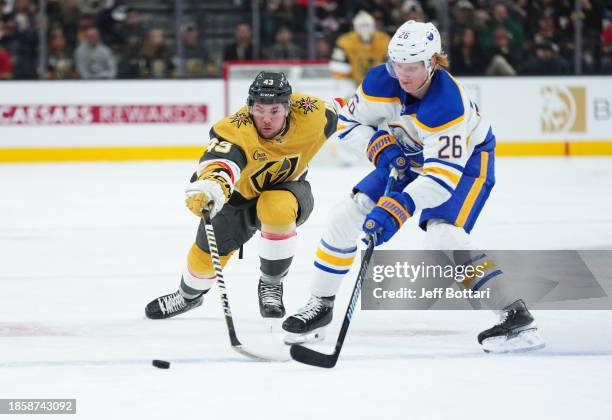 Paul Cotter of the Vegas Golden Knights battles against Rasmus Dahlin of the Buffalo Sabres during the first period at T-Mobile Arena on December 15,...