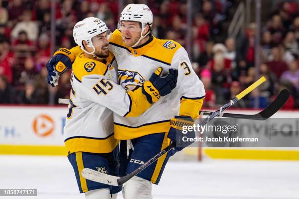 Jeremy Lauzon of the Nashville Predators celebrates his goal with Alexandre Carrier in the third period during their game against the Carolina...